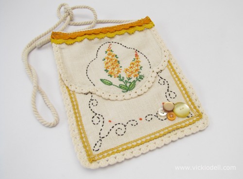 vintage needlework sewn onto a plain bag