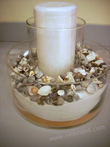 clear cylinder vase, sand, sea shells, candle