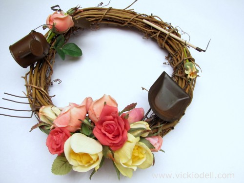 silk flowers, miniature garden tools, grapevine wreath
